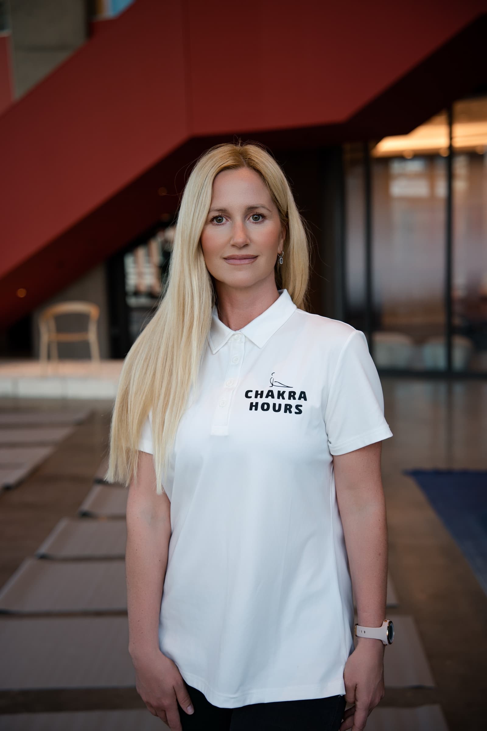 Nina Mua, founder of Chakra Hours, in her Chakra Hours polo at an onsite sound bath in Dallas, introducing Chakra Hours in a two-minute video
