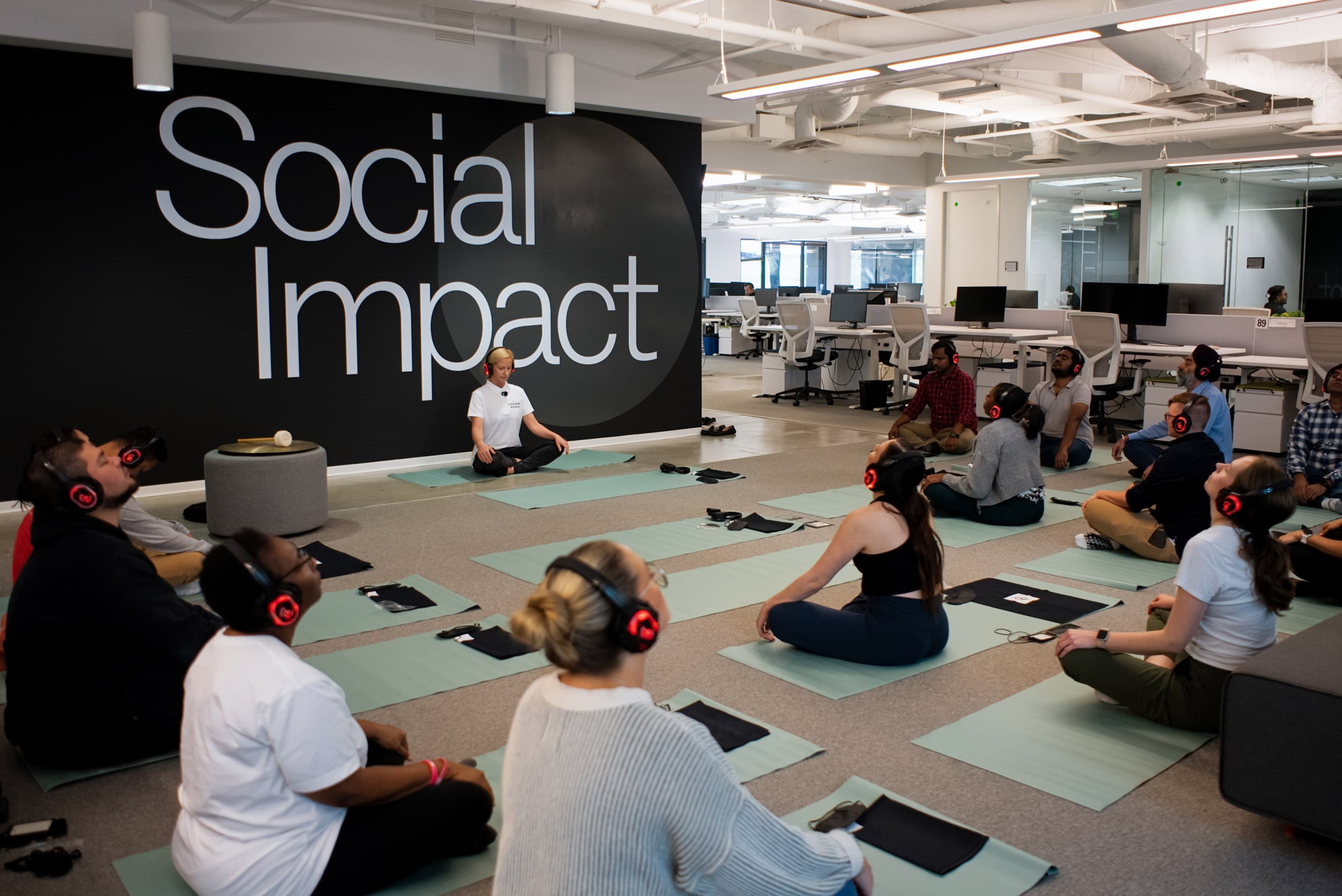 Employee stretching during a workplace wellbeing session - benefits of employee wellness programs - Chakra Hours
