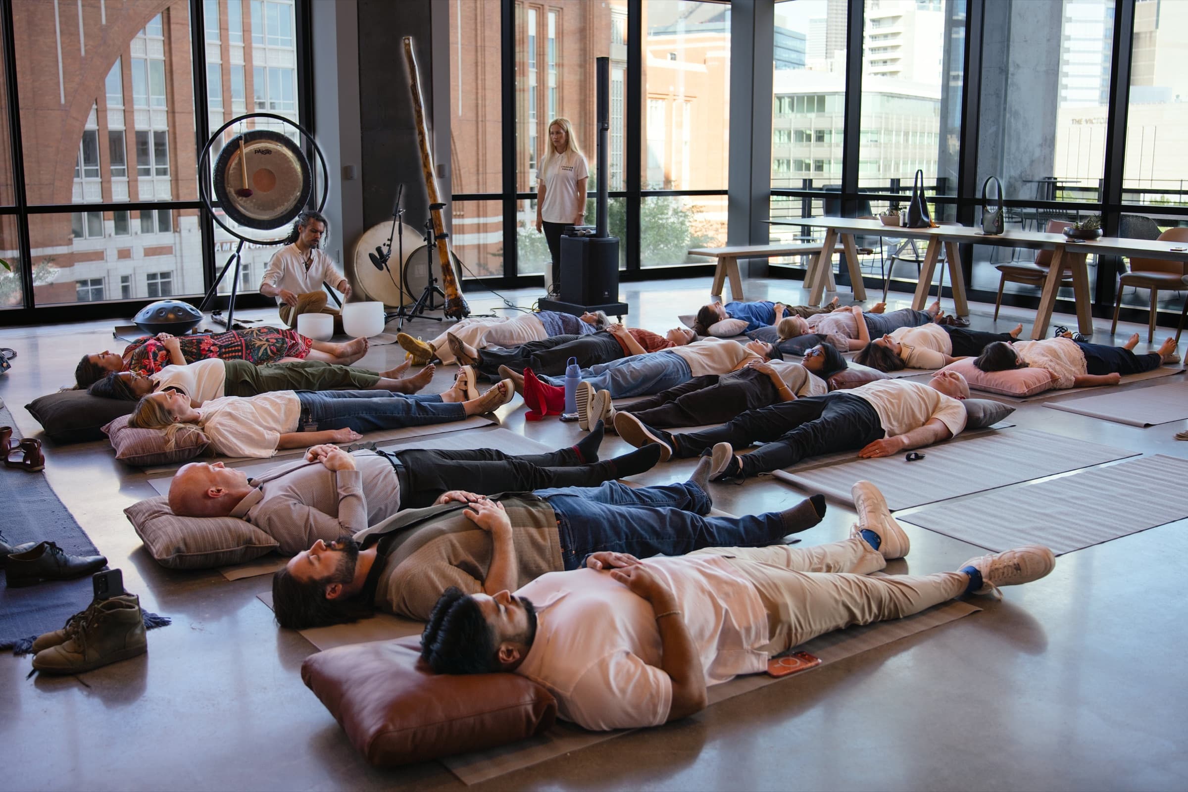 Employees resting during a corporate sound bath session with crystal bowls - sound bath in the workplace - Chakra Hours
