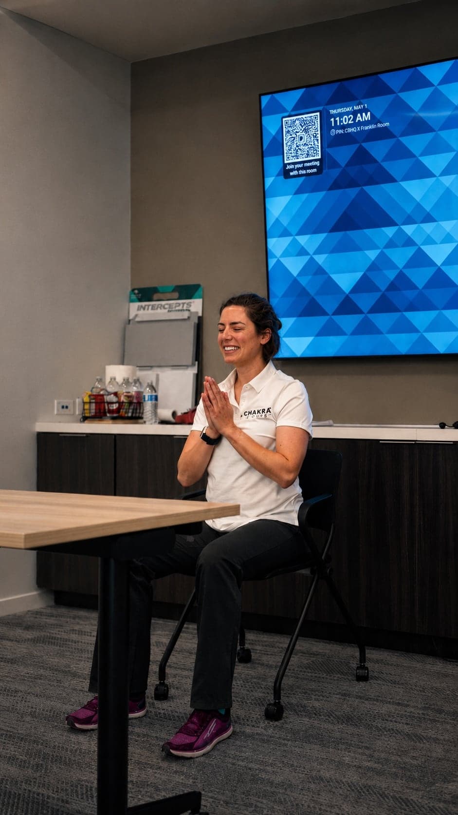 A live chair yoga session running in a Dallas office — Mental Health Awareness Month ideas for work — Chakra Hours