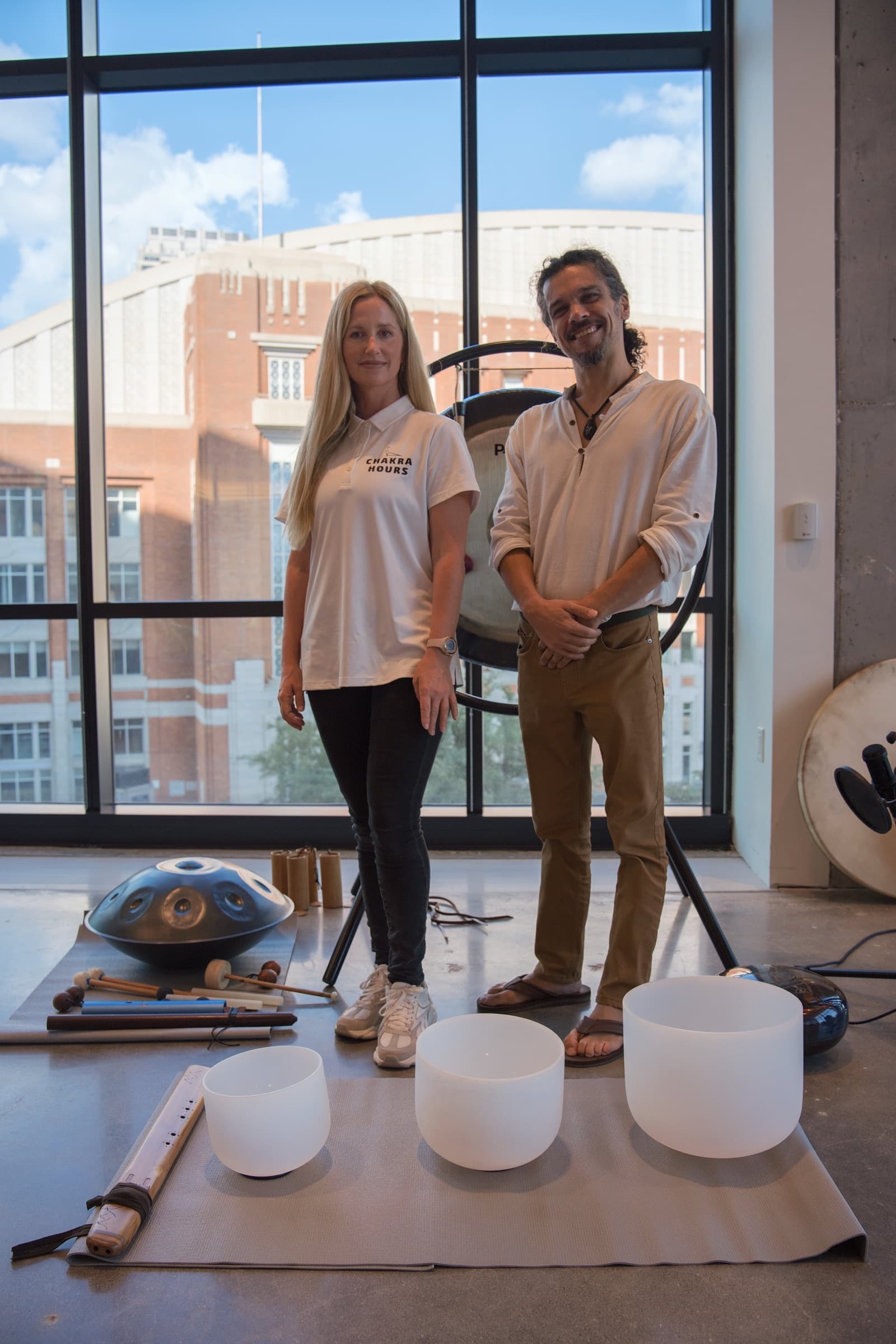 Nina Mua and Chris, Chakra Hours facilitators, with the gong and crystal singing bowls before an onsite sound bath in Dallas